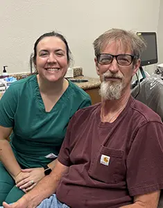Dental professional with a program participant in a dental treatment room